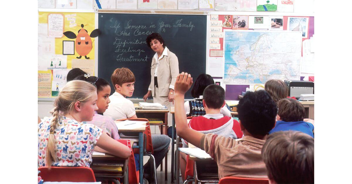 teacher teaching his students in a classroom