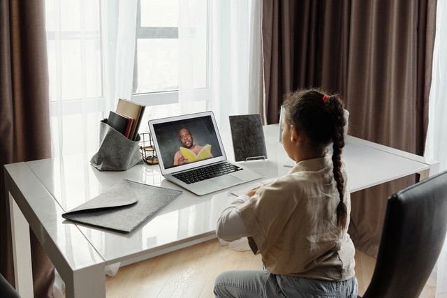 girl in front of laptop having online class