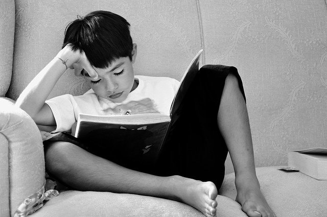 Child sleeping while reading book