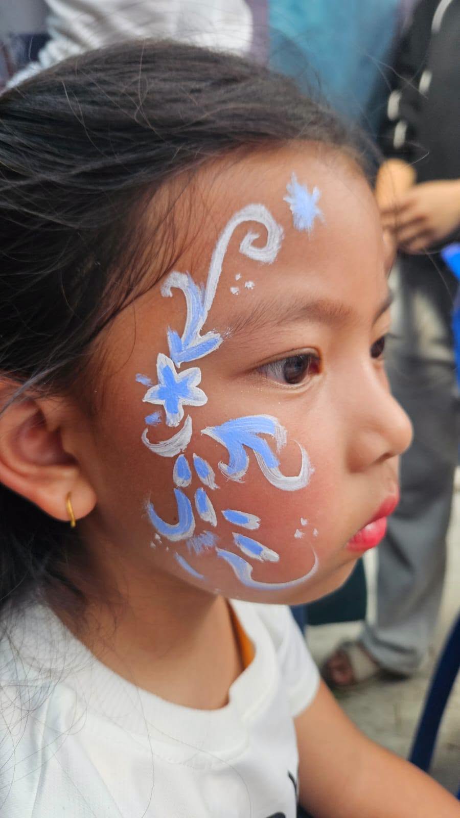 Golden Peak High School Student Council operating fundraising face painting stall at Boudha Mahotsav 2083